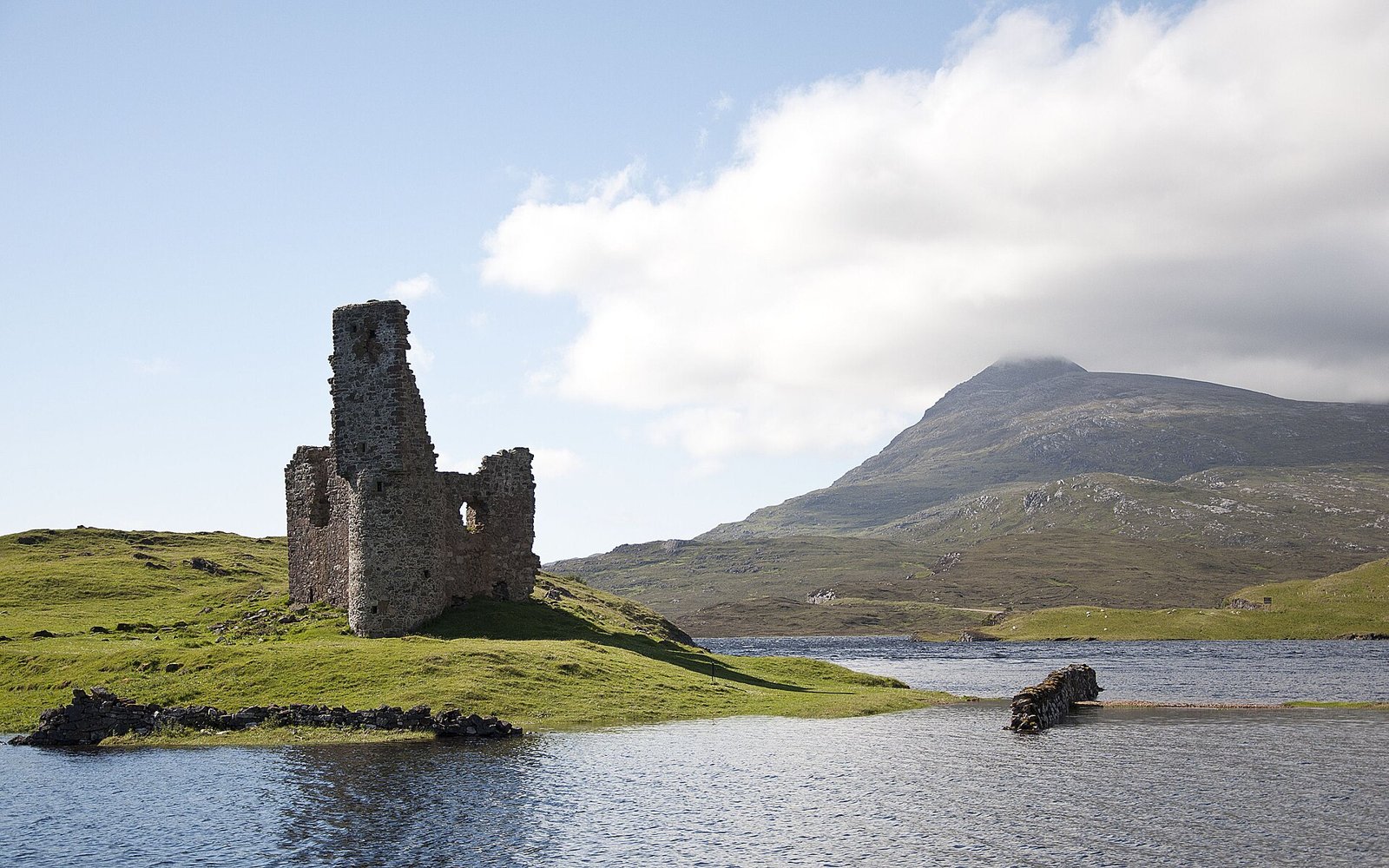 The ruined tower of Ardvreck Castle on a promontory in Loch Assynt