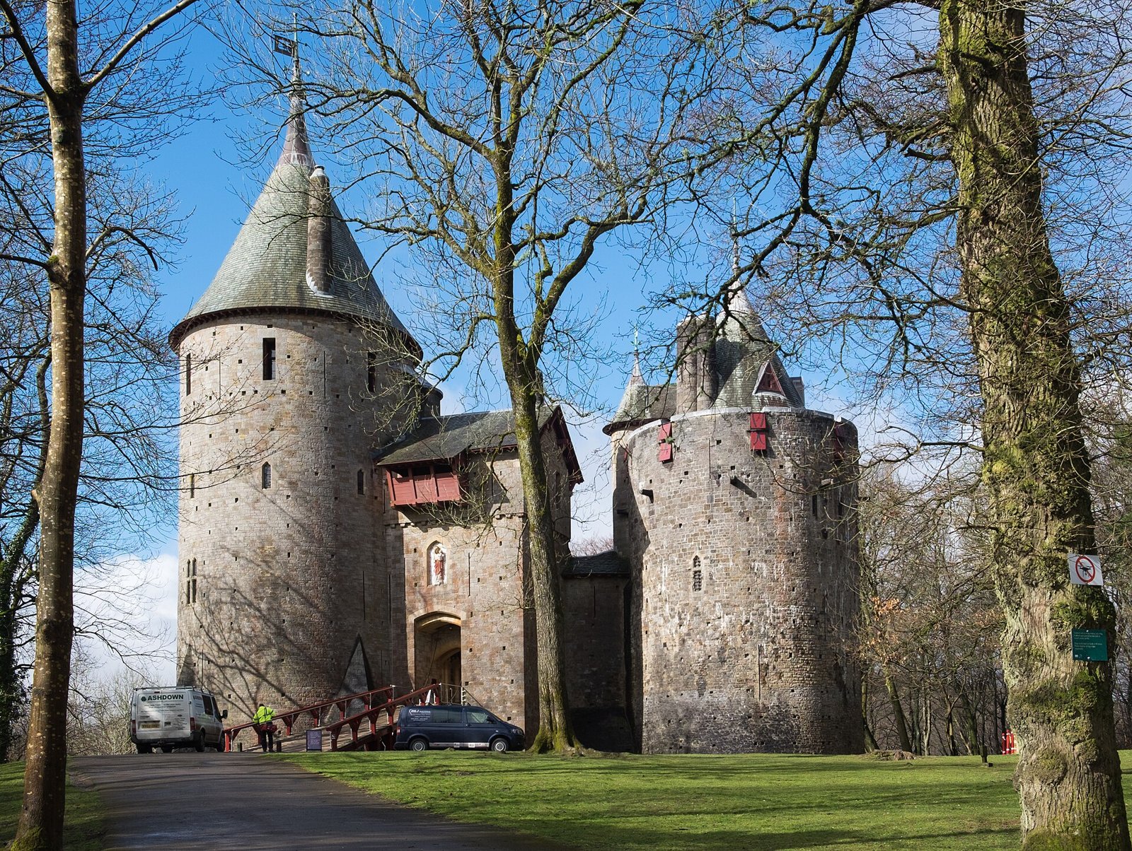 Castell Coch's red sandstone conical towers among woodland