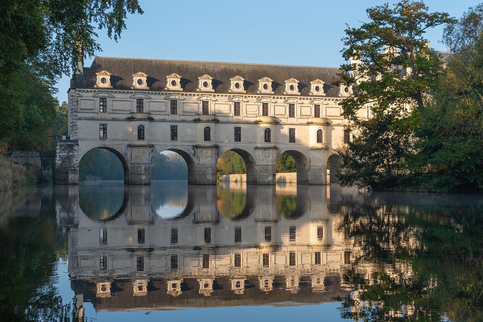 Château de Chenonceau with its arches reflected in the river Cher