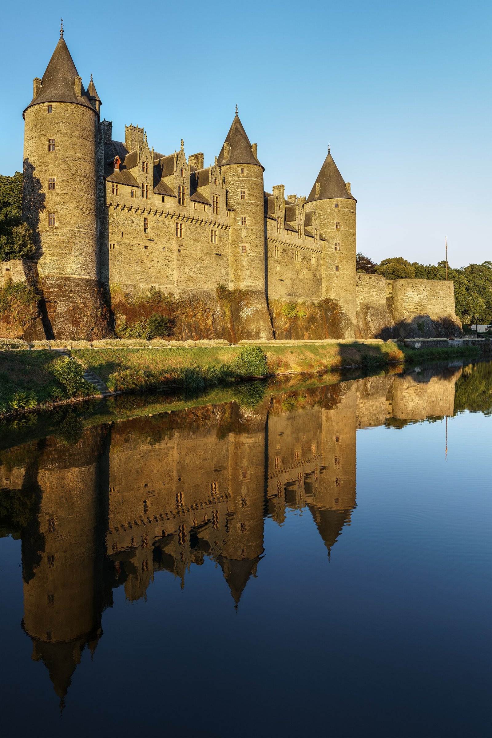 Château de Josselin's towers reflected in the river Oust in Brittany
