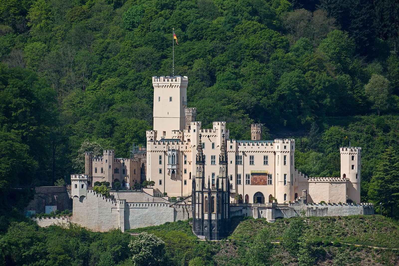 The yellow Gothic Revival walls of Schloss Stolzenfels above the Rhine near Koblenz